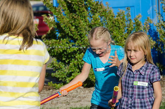 Online instructors gather with their families for an eveing of BBQ and games.