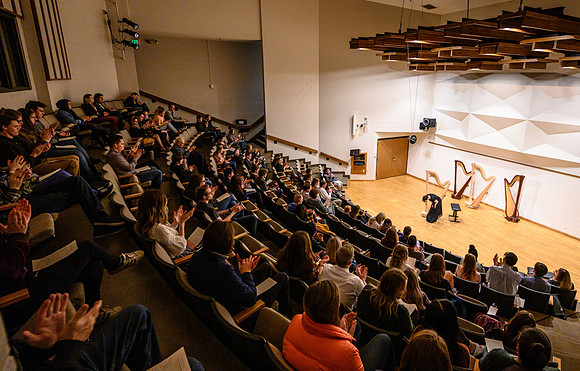 The harp ensemble performs in the recital hall in the Snow building.