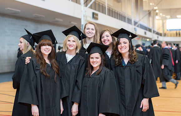 Graduates wait inside the gym area preparing to enter Commencement ceremony. Photo by Leanna Davidson