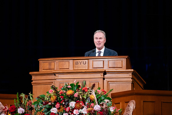 Elder and Sister Boom speak at devotional in the BYUI Center.