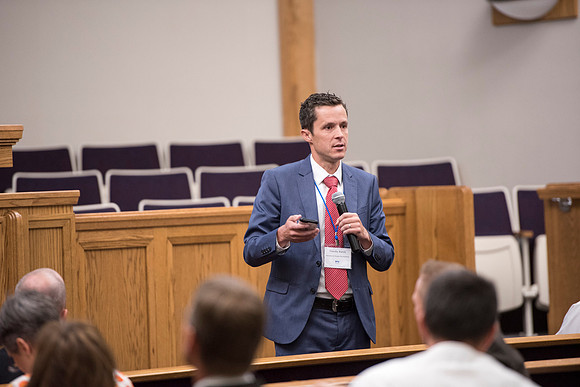 Tim Rarick and Cole Ratcliffe hold a discussion during the faculty conference.