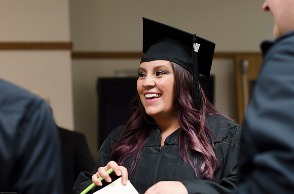 Student Graduates at the College of Education and Human Development Convocation in the HInckley Chapel.