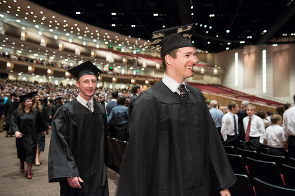 Graduates gather and march in during the processional for April 2014 Graduation ceremonies in the BYU-Idaho Center.