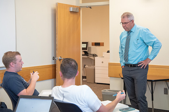 Instructor Brent Bean teaching Communication class.