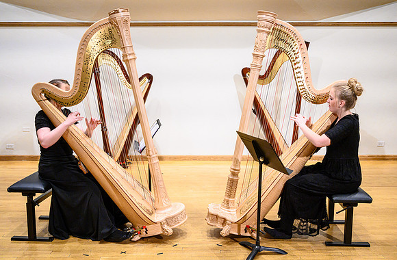 The harp ensemble performs in the recital hall in the Snow building.
