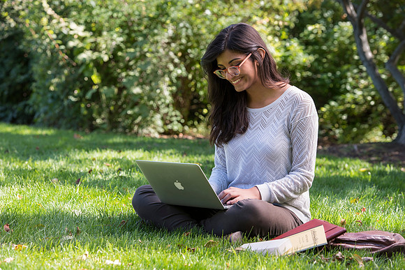 Student Noor Sofi poses in the Gardens for online learning.