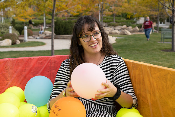 Students who volunteer to participate sit in the ball pit and ask each other questions which are found on the balloons. Video is being produced for Student Living.