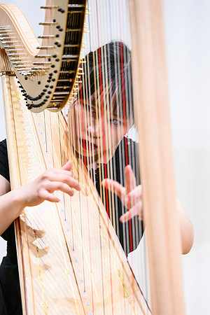 The harp ensemble performs in the recital hall in the Snow building.
