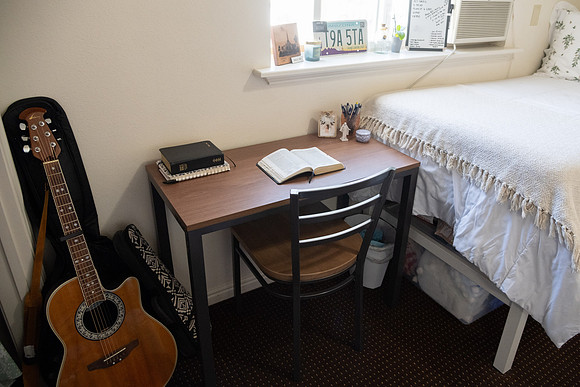 Scriptures on a desk in a clean student bedroom