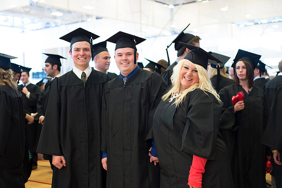 Graduates wait inside the gym area preparing to enter Commencement ceremony.