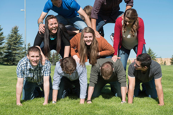 Student models interact and smile for marketing purposes that will be used for the new Campus Housing next to The Ivy.