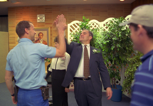 1997, President Steven D. Bennion gives one of his famous "High Fives" at his farewell reception.
