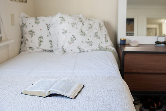 Scriptures on a desk in a clean student bedroom