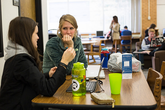 Students prepare for their classes, in the McKay Library.
