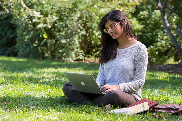 Student Noor Sofi poses in the Gardens for online learning.