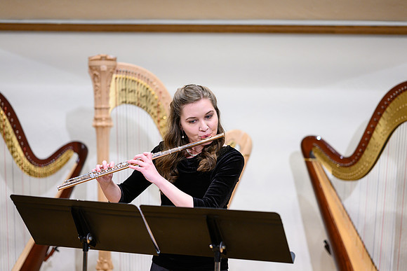 The harp ensemble performs in the recital hall in the Snow building.
