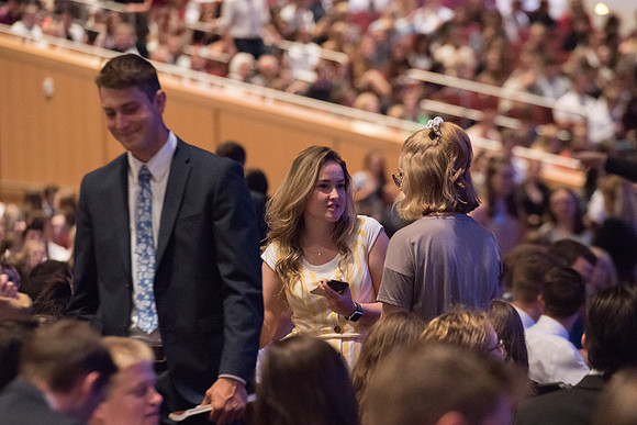 BYU-Idaho Devotional. Guest speaker Elder David A. Bednar and his wife. Students getting ready to listen. Fall Semester
