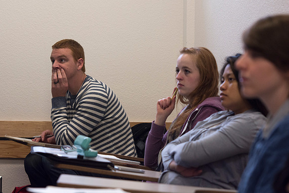 Students observe the message that the movie , "Packing Heat," during the 2014 Spring Semester in Sister Jenson's Criminology class.