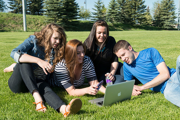 Student models interact and smile for marketing purposes that will be used for the new Campus Housing next to The Ivy.