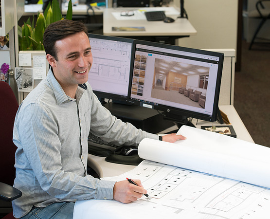 Sterling Kreutzer, a Construction Management major working with architectural drawings and 3D design at the University Operations Facility.