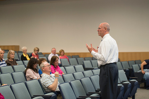 Adult participants listen to a class presented by Phil Packer.