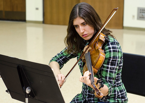 A member of the Shanghai String Quartet working with student ensembles.