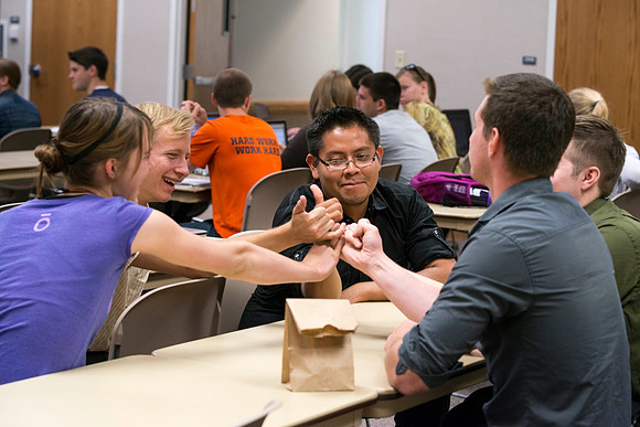 Political Science students in Brother Adamson's class make pinky promises to each other that they will not cheat on the game they are about to play during class.