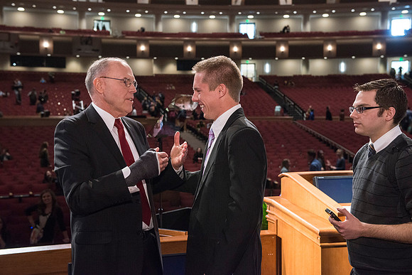 Russel T. Osguthorpe, the president of the the General sunday School, greets students and employees after devotional.
