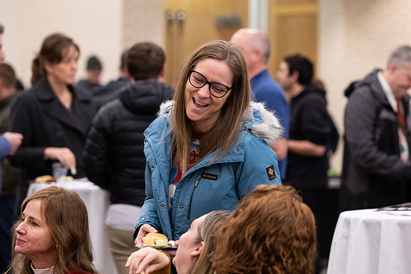 Employees gather for the annual Christmas gathering with President and Sister Meredith.