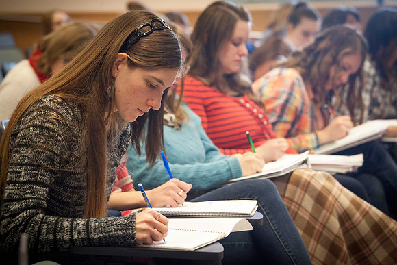 Students eagerly take notes as Brother Madsen covers various Geography topics.