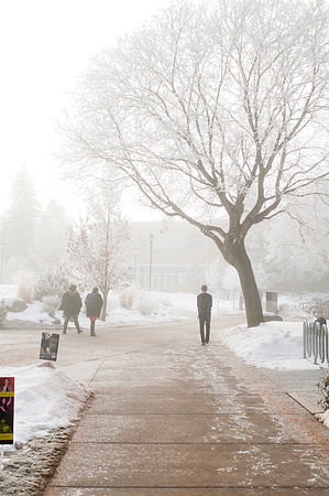 Students walk to class on a foggy, winter morning on campus