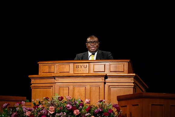 Elder Egbo speaking to students in the BYUI Center.