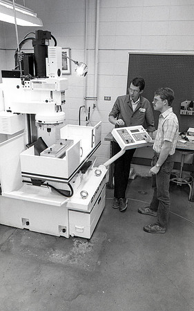 Student works alongside teacher in Manufacturing Technology. December 1990.