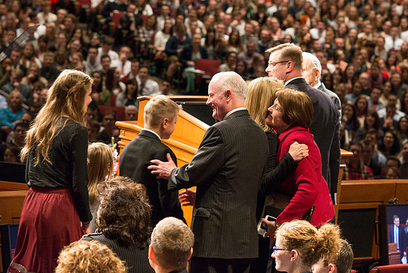 Brigham Young University-Idaho's newest President of the University, Clark Gilbert, walks up to the podium with his family and are greeted by President Kim B. Clark, Sue Clark and Russell M. Nelson. P