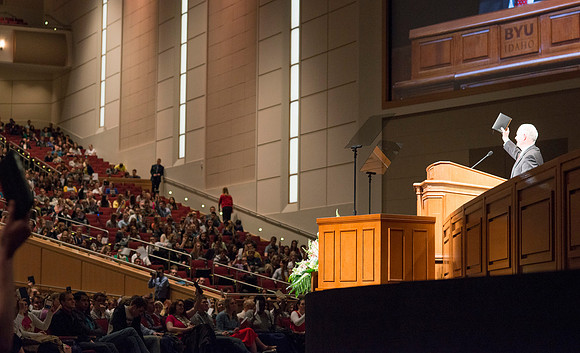 President Clark asks students to show their readiness to learn by raising the scriptures at the start of devotional.