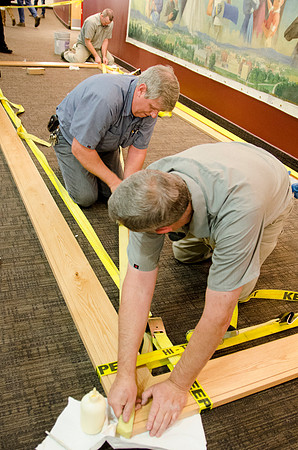 Campus faculty glues together the frame that will encompass a new mural in the I-Center Lobby.
