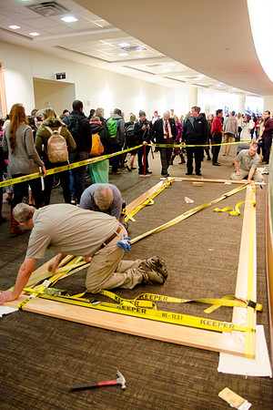 Campus faculty glues together the frame that will encompass a new mural in the I-Center Lobby.