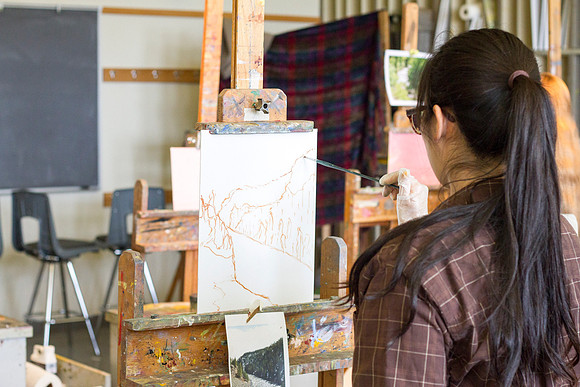 A student in Brother Bodily's Painting class paints a beautiful landcape in the Spori Building.