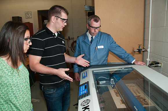 Ron Kinville operates the new Kiewit lazer cutter that was donated to the Architecture and Construction Dept.