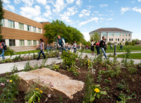 Students walking between classes during the spring semester in the Spori Quad.
