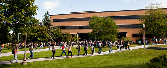Student traffic on campus in front of the Smith building.