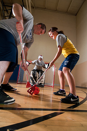 In the Broom Hockey shot:<br/>- Lacey Jones (broom hockey player)<br/>- Kimberly Gordon (Broom hockey goalie)<br/>- Brent Junior Elkington (Broom Hockey player)