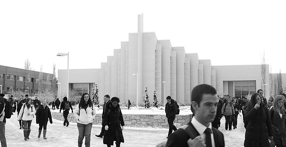 Bundled students walking to class though the John Taylor Building Quad during a snowy Rexburg winter.
