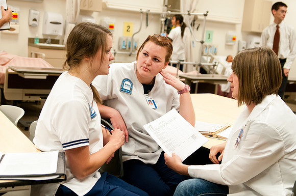 Sister Holly Forbush teaches students in the Nursing Lab.