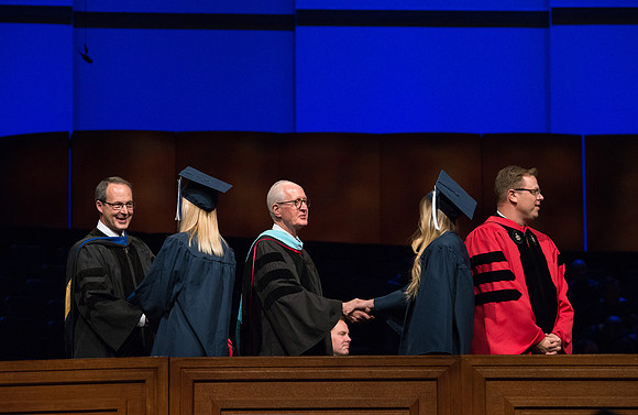 College of Agriculture and Life Sciences Convocation in the Byu-Idaho Center. Elder Wilson and President Clark along with College Dean, John Zenger congratulate the graduates.
