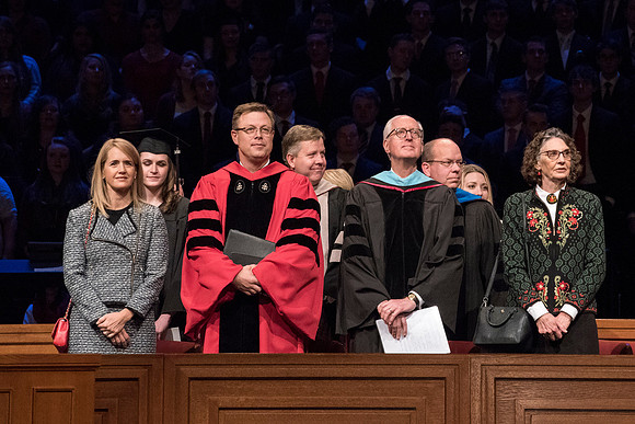 (Left to right) Christine Gilbert, President Clark G. Gilbert, Elder Larry Y. Wilson, and Lynda Wilson stand waiting for Commencement to begin. Photo by Ryan Chase.