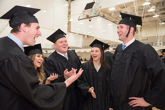 BYU-Idaho graduates joke and laugh with each other prior to parting ways following graduation. Photo by Ryan Chase