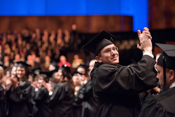 A graduates takes a moment to show his appreciation to his family. Photo by Ryan Chase