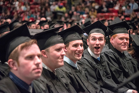 Graduate Justin Pearson gets excited that he has finally graduated with his Bachelors degree. Photo by Ryan Chase