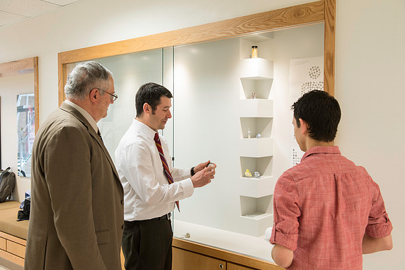Brian Walton makes sure the displays fit and lay correctly within the city-scape structure.  (Brian Tonks, Brian Walton and Forest Gahn)